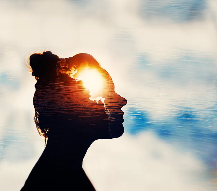woman silhouette with sun rising within her used to illustrate past life regression